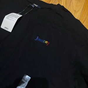 Black T shirt with Journey embroidered in the front and printed on the back